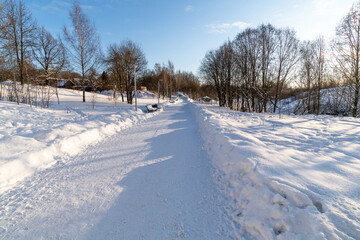 Fototapeta na wymiar country landscape with snowy road in Russia