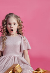 Cute little girl with gifts close-up,surprised face