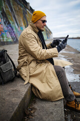 Traveling Man With Mobile Phone And Hat, In winter City, Urban Space.