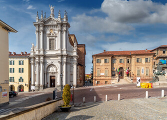 Bra, Cuneo, Piedmont, Italy - October 28, 2021: Town hall building of Bra (project by Bernardo Vittone 1897) and the parish church of Sant Andrea Apostolo in piazza Caduti per Liberta