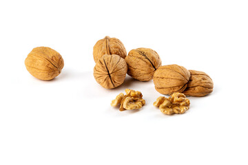 A handful of walnuts, shells on a white background.