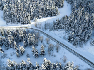 Aerial view on the road and forest at the winter time. Natural winter landscape from air. Landscape...