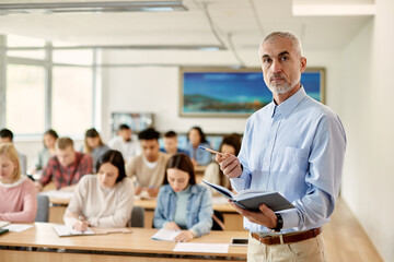 Portrait of mature university teacher during lecture in the classroom.