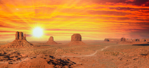 Sunset sky with streaks of red color over Monument Valley, a region of the Colorado Plateau between...