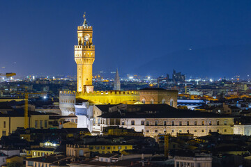 Fototapeta na wymiar Arnolfo Tower of Palazzo Vecchio on Signoria square. Italian renaissance. Night Shot from Michelangelo square. Florence, Tuscany - 12 Jan 2022