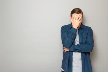 Portrait of unhappy disappointed mature man making facepalm gesture