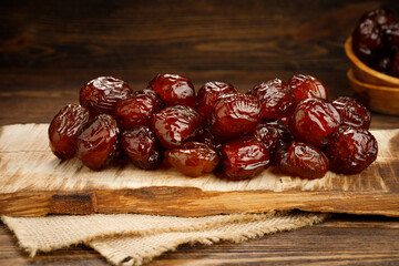Dried dates fruit on a old wooden table. Arabian food.