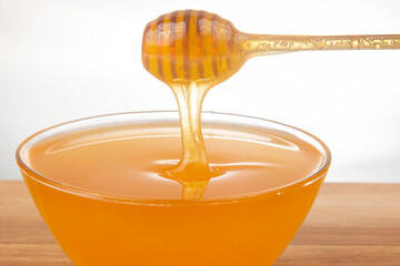fresh fragrant honey drips from a spoon into a plate. organic vitamin nutrition. dessert food