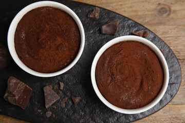 Delicious fresh fondant with chocolate chunks on wooden table, top view
