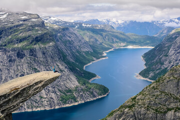 Fototapeta premium Sitting woman on the edge of a rock 