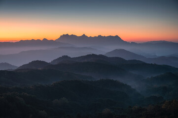 Scenery of Doi Kham Fah viewpoint with sunrise over Doi Luang Chiang Dao mountain with foggy in tropical rainforest at national park