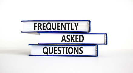 FAQ frequently asked questions symbol. Concept words FAQ frequently asked questions on books on a...