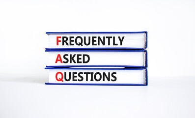 FAQ frequently asked questions symbol. Concept words FAQ frequently asked questions on books on a...