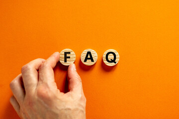 Fototapeta na wymiar FAQ frequently asked questions symbol. Concept words FAQ frequently asked questions on wooden circles on a beautiful orange background. Business and FAQ frequently asked questions concept.