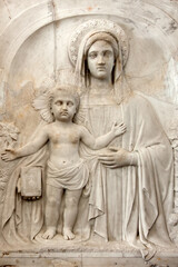 Closeup to Madonna with child traditional religious bas relief