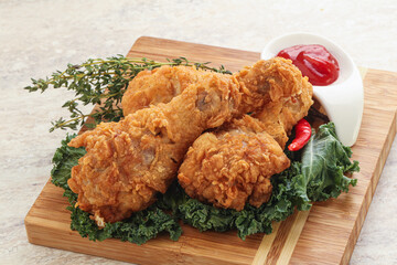 Fried chicken drumsticks with tomato sauce