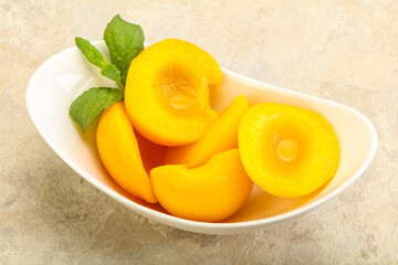 Sweet ripe canned peaches with mint