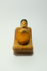 Jesus in a manger from a wooden christmas crib with white background, abstract