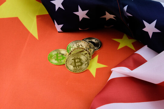 Cryptocurrencies on top of the Chinese and US flags. Power struggle concept.