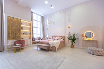luxurious modern bedroom interior of an expensive spacious light stylish apartment. upholstered furniture and decorative lighting, soft pastel colors and cozy atmosphere