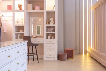 Fototapeta na wymiar luxurious modern dressing room interior in a chic bright apartment in pink. trendy lighting, stylish luxury design and white furniture