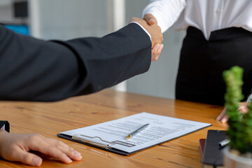 The job interviewer and the job applicant are shaking hands after the job interview is finished. The concept of recruiting employees to work in the company, vacant positions.