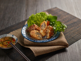 Seafood Fried Spring Roll in colorful plate on wooden table