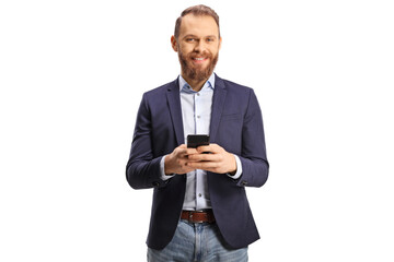 Bearded guy in suit and jeans using a mobile phone and smiling