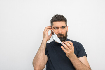 A young man with a beard and masks. Security measures. Masked man. Isolated background.