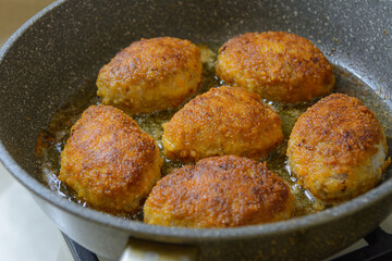 Turkey cutlets in a pan. Homemade schnitzel. Selective focus, top view.