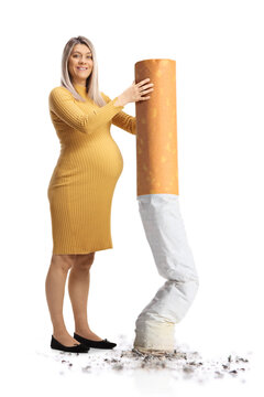 Pregnant woman smiling and putting off a big cigarette