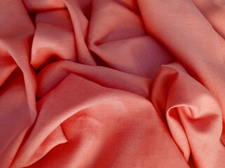 Light red natural linen fabric. Woven  texture background. Coral color textile drapery for sewing,...