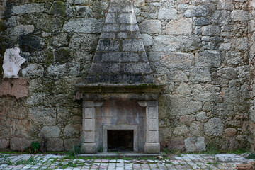Stone fireplace on an antique old abandoned house in Sortelha, Portugal