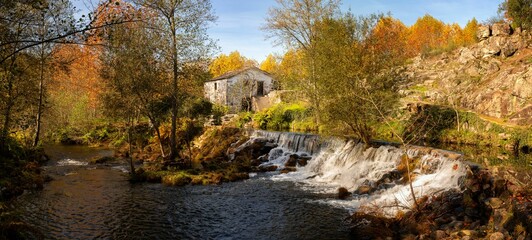Mondim de Basto panorama waterfall with a mill house at sunset in Portugal