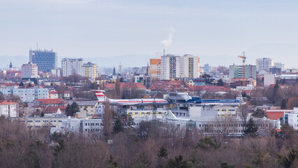 panorama of the city of Graz in Austria with two passenger airplanes on the roof of a hotel used as a restaurant