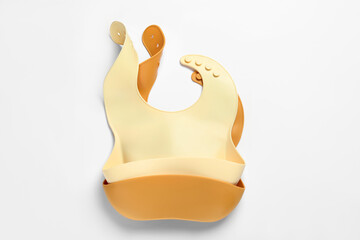Color silicone baby bibs isolated on white, top view