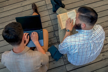Conceptual photography: old and new source of information. Digital gadget as upgrade of book. Top...