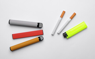 Lighter, electronic and regular cigarettes on white background, top view
