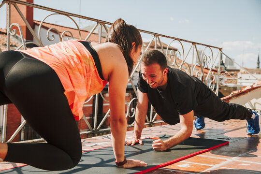 A couple exercising on their rooftop