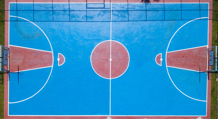 Multisport court seen at 90 degrees from a drone in blue and red colors, where you can see the...