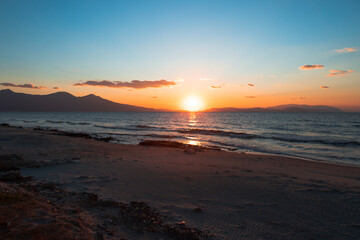 sunset between samos island, greece and dilek peninsula, turkey.
