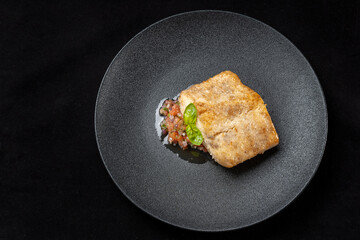 Delicious fish fry served on a beautiful plate, laid out on tartare.