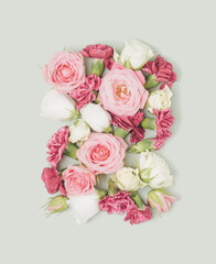 Spring flowers arranged on a pastel green background. Blooming retro spring flat lay.