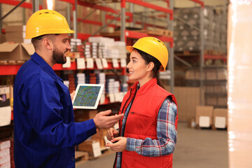 Manager and worker at warehouse. Logistics center