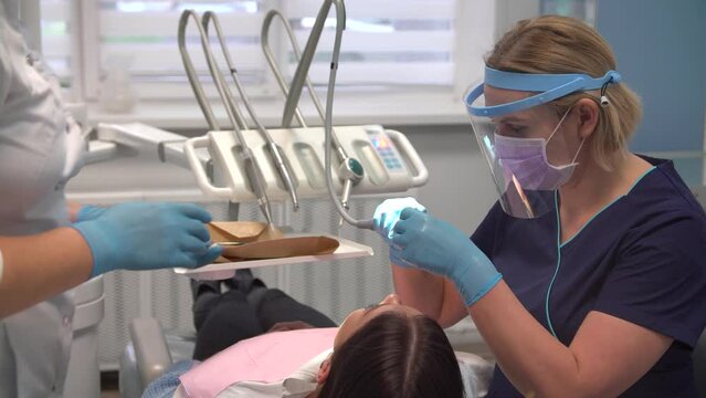 Female dentist at work with assistant