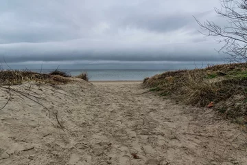Photo sur Plexiglas La Baltique, Sopot, Pologne Rain clouds over the sandy beach of the Baltic Sea. Winter seascape