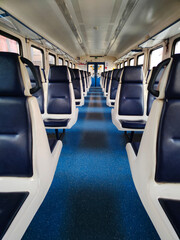 Obraz premium a symmetrical Vertical photo inside of empty seated carriag in clean modern train