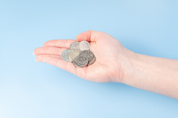 A small woman hand with russian coins. Hand with money. Budget. Go shopping.