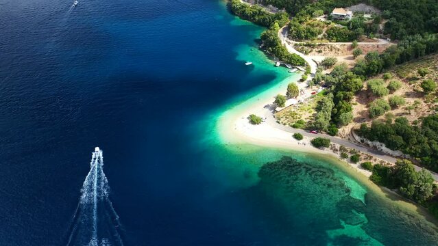 Aerial drone video of tropical paradise exotic island bay covered in limestone trees with emerald crystal clear beach visited by luxury yachts and sail boats in Caribbean destination