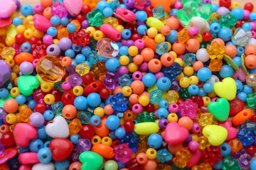 Many different bright beads as background, closeup